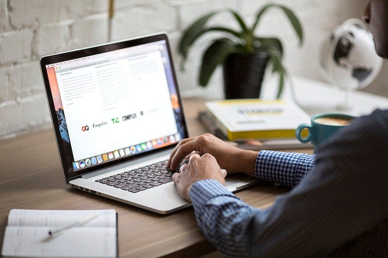 Remote work illustration of a man sitting next to a computer